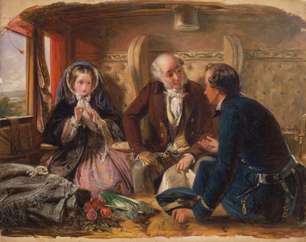 A young man is engaging a young girl and her father in conversation in a train carriage.