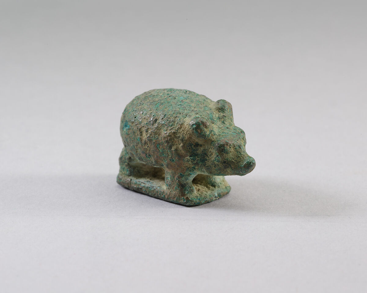 A small cupreous metal statue of a hedgehog.  